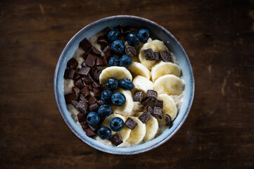 oatmeal bowl with fresh banana and blueberries and chocolate chunks