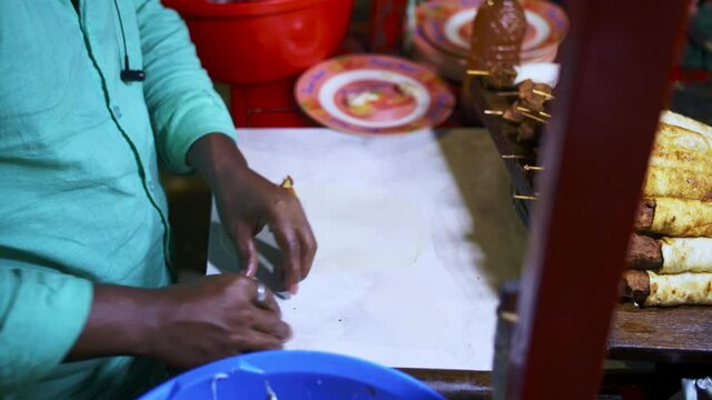 Making a Kebab Roll from a street stall in Dhaka at night