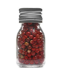 Red pepper in glass jar isolated on white background