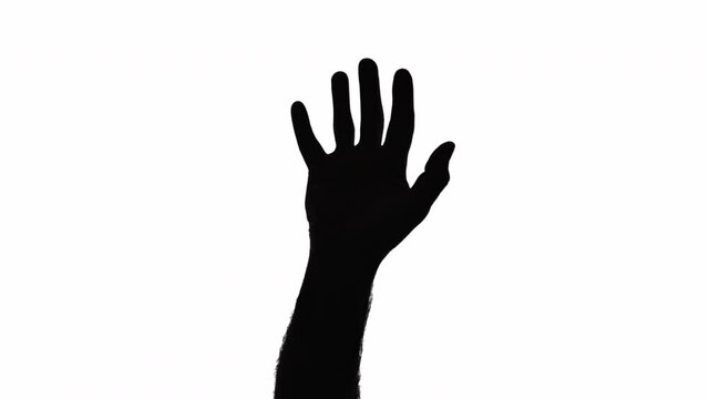A silhouetted male hand appearing and gesturing for help, open palm, imploring to stop.
