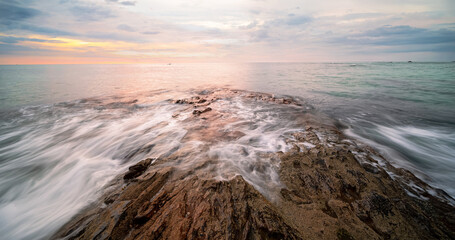 Rocky seashore and wave during sunset sky , Seascape