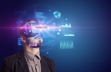 Businessman looking through Virtual Reality glasses