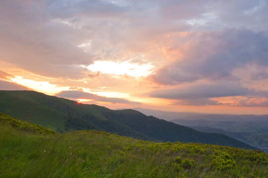 sunset in the mountains with beautiful colorful clouds © Yurii Klymko