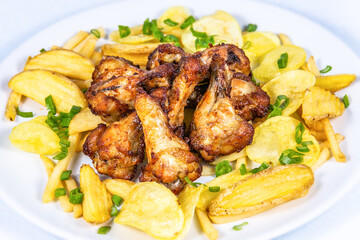 Fried chicken thighs with potato chips. The food in the restaurant. Food styling and restaurant meal serving.