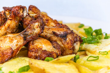 Fried chicken thighs with potato chips. The food in the restaurant. Food styling and restaurant meal serving.