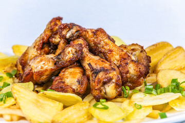 Fried chicken thighs with potato chips. The food in the restaurant. Food styling and restaurant meal serving.