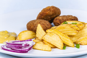 Pork meatball with potato chips. The food in the restaurant. Food styling and restaurant meal serving.