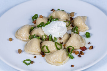 Potato dumplings with bacon and spring onions. The food in the restaurant. Food styling and restaurant meal serving.