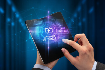 Businessman holding a foldable smartphone, technology concept