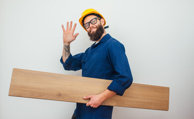 Cheerful worker - craftsman in work clothes with floor laminate in hands insulated on studio background. Collage in magazine style. Flyer with trendy colors, copyspace for ad. Your text here.