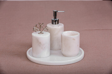 Fototapeta na wymiar marble bathroom accessories, liquid soap dispenser