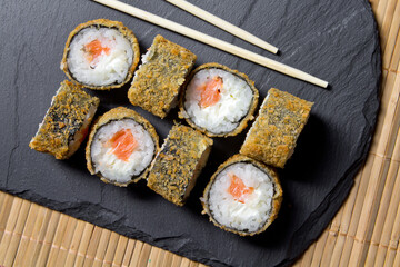 Sushi roll tempura with prawns on the mats background. Top view of sushi . Sushi food photo for menu.