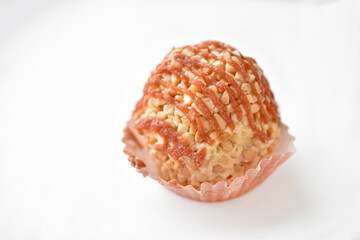 Nutty creamy round cake on a white background