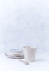 Traditional, handcrafted ceramic on bright wooden background. Soft focus. Copy space.	