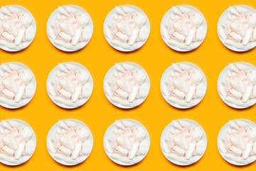 Pattern of white chips in round bowls on yellow background.