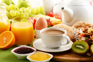 Breakfast served with coffee, orange juice, egg and fruits