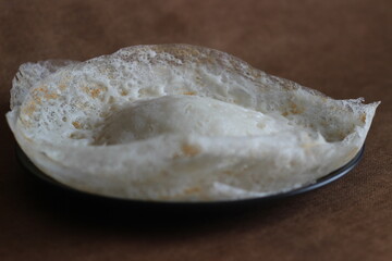 Laced Rice Crepes or Fermented rice pancakes made with fermented rice batter and coconut milk.