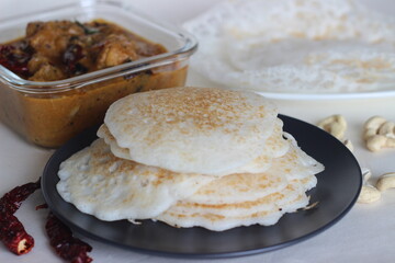 Rice pancakes and Hoppers. Two types of red rice breakfast dishes along with chicken curry made with home ground masala