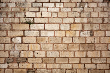 Old wall built of brick and stone, historic background