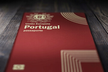 Close-up of a Portuguese passport on a dark wooden board, citizenship by Investment - obrazy, fototapety, plakaty
