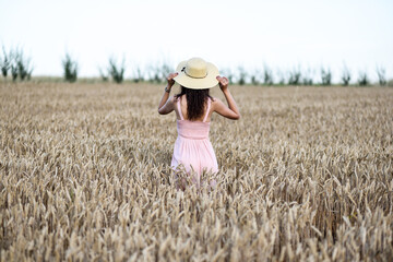 Naklejka na ściany i meble A girl in a wheat field