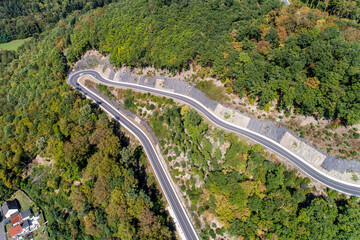 Winding road serpentine from a high mountain pass in the rhine village Bendorf Sayn Germany Aerial view