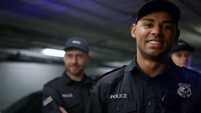 Policeman smiling at camera. Positive cop in uniform posing at camera