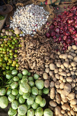 Praying Muslims in front of a shrine. They wear white prayer caps and stand. You can see them only from behind. Normal perspective. Day. 
