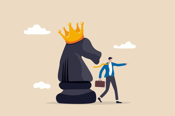 Strategy to win business competition, leadership to make decision, business challenge or tactic to overcome obstacle concept, smart businessman pointing finger to direct chess knight with king crown. © Nuthawut