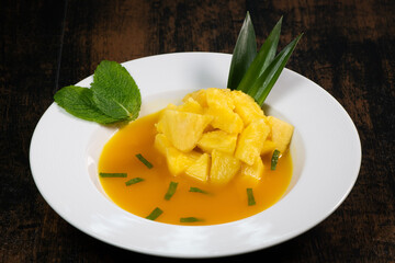Fresh pineapple dessert recipe with mint orange coulis, hight quality photo