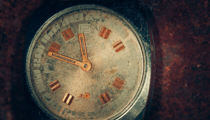 An old vintage broken mechanical watch. Dark grunge background