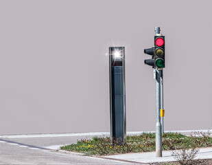 a speed camera (radar) for traffic monitoring is behind a traffic light