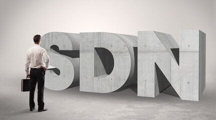Rear view of a businessman standing in front abbreviation