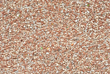 The texture of the wall is made of small orange and white stones.