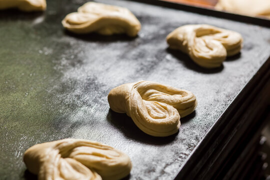 Heart shaped dinner rolls on tray. Food factory.