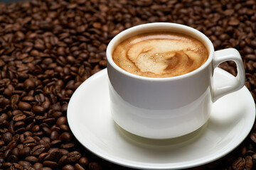 Cup of espresso coffee on Background made of roasted brown coffee beans