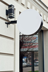 Round sign on the building. Copy space and space for text. Mockup for design. Blank template for advertising.