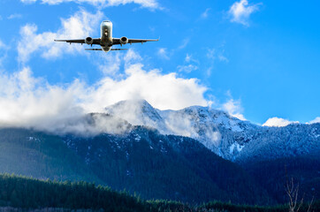 Fototapeta na wymiar flight of the airplane (jet) over beautiful sky and snow mountains
