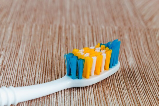 White toothbrush without toothpaste on a light background.