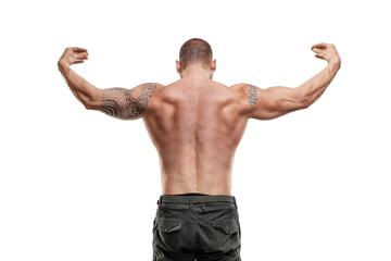 Tattooed male bodybuilder posing over white background. Fitness workout concept, muscle groups, watch your body.