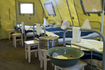 Fototapeta na wymiar empty beds inside a military field hospital that were inside