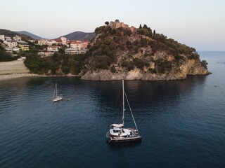 Fototapeta na wymiar Aerial View Of Catamaran And A Yacht Docked In Marina Of Valtos Tropical Beach In Parga, Tourist Destination In Greece