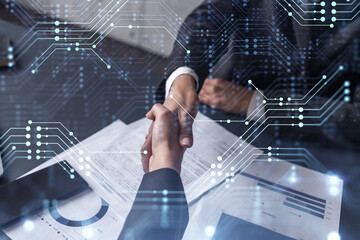 Handshake of two businesswomen who enters into the contract to develop a new software to improve...