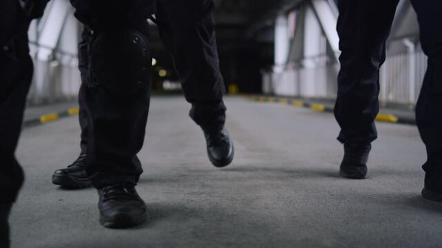 Closeup SWAT police officers legs walking in urban building