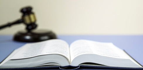  law book with a wooden judges gavel on table