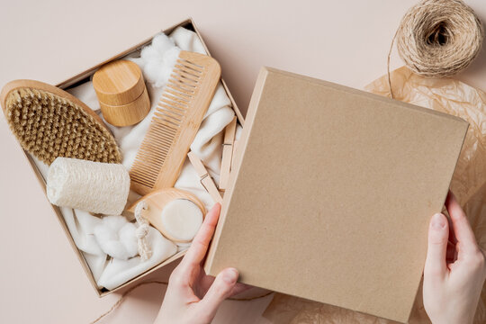 Woman preparing gift beauty box with natural cosmetics products. Zero waste, eco-friendly, sustainable lifestyle.