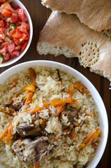 pilaf, salad and bread on a wooden table