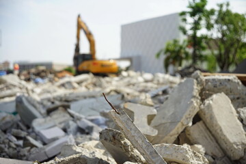 Concrete scraps of old buildings demolished to create new, more modern buildings by large machines.