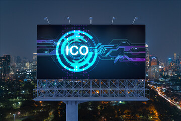 ICO hologram icon on billboard over panorama city view of Bangkok at night time. The hub of...