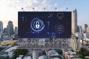 Padlock icon hologram on road billboard over panorama city view of Bangkok at sunset to protect business, Southeast Asia. The concept of information security shields.